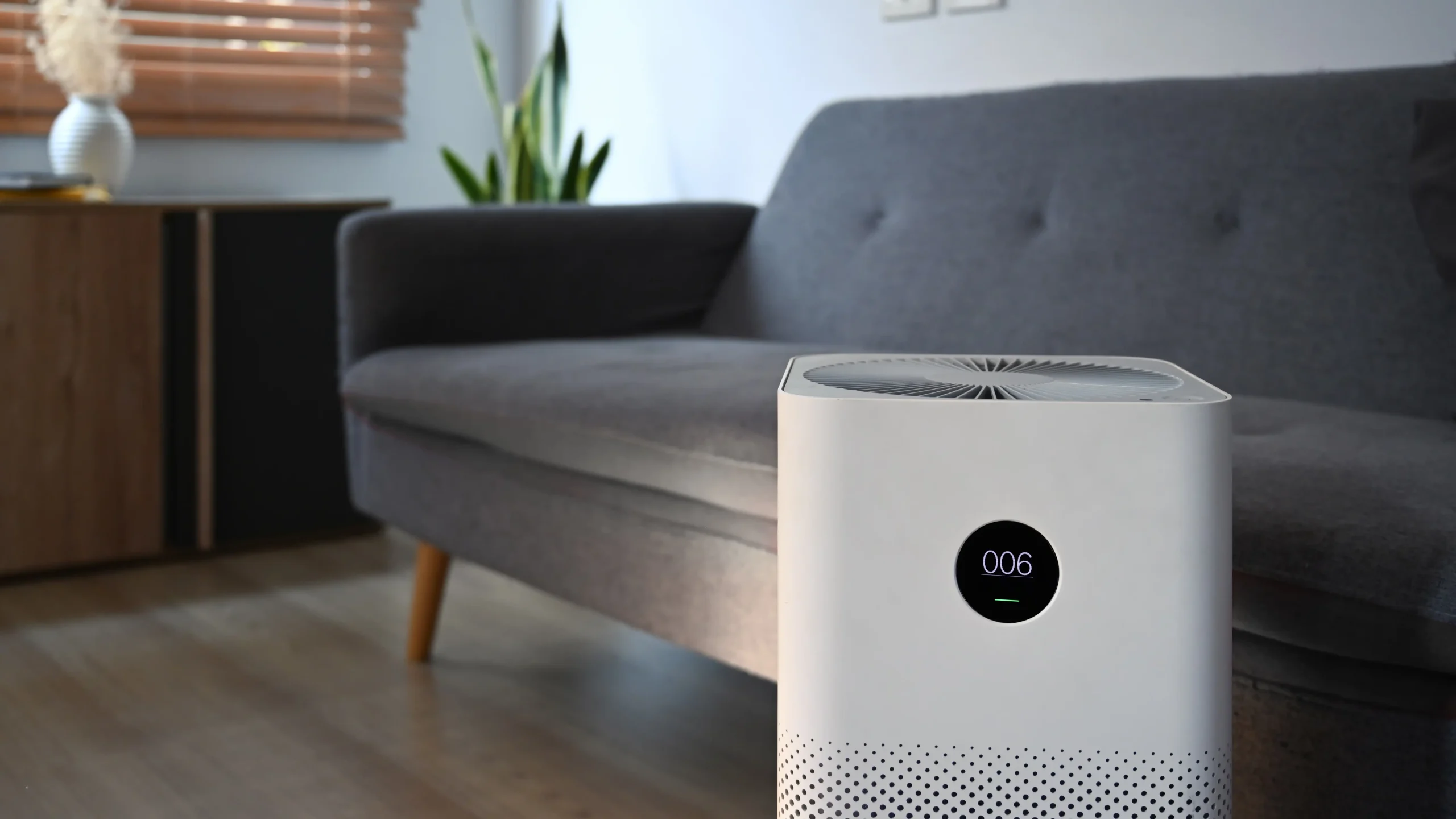 modern-air-purifier-on-wooden-floor-in-bright-livi-2023-11-27-05-21-26-utc